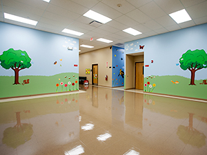 Room with grass and trees painted on walls