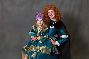 Two girls smiling for a photo in their dresses