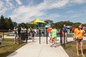 Adults watching kids play at the park